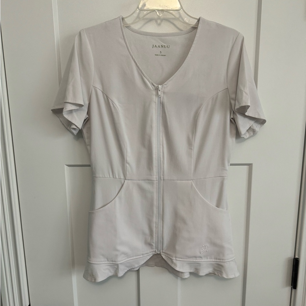Original Jaanuu Scrub top with scalloped bottom.